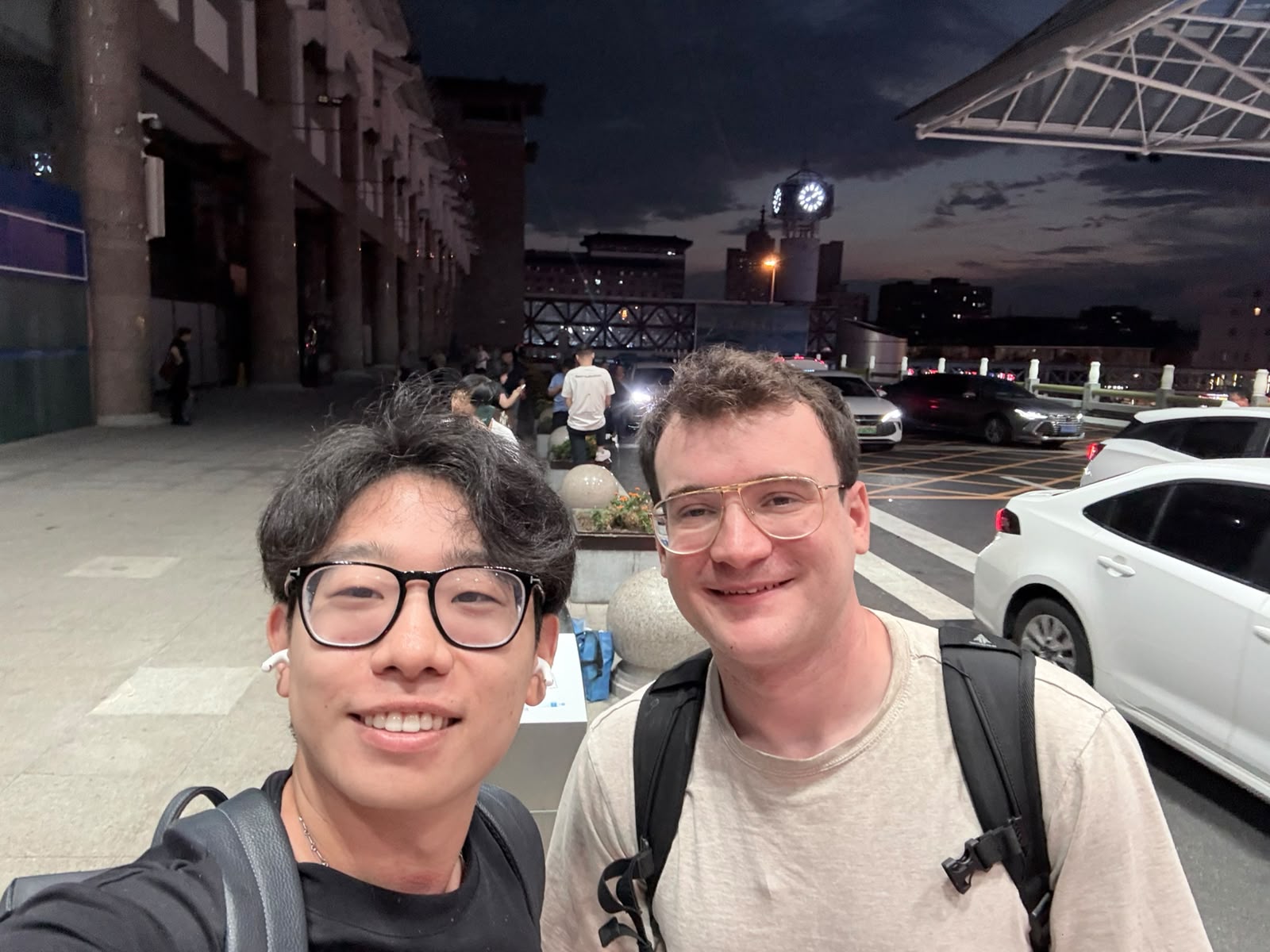 Yushu and Nick outside a train station at night